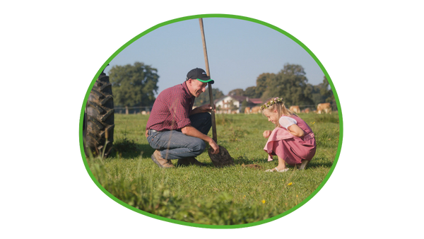 Landwirt mit Kind auf dem Hof